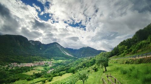 Scenic view of mountains against cloudy sky