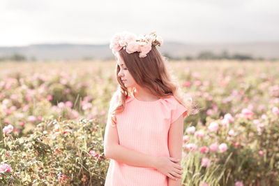 Teenager girl wearing wreath standing at farm