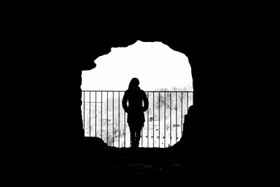 Silhouette of people standing in tunnel