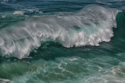 High angle view of waves rushing towards shore