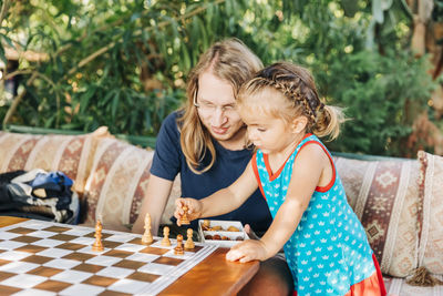 Father and daughter playing chess