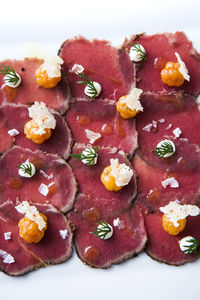 Beef carpaccio on white background