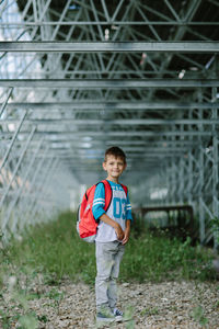 Portrait of boy standing in greenhouse