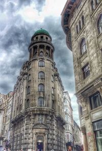 Low angle view of building against cloudy sky