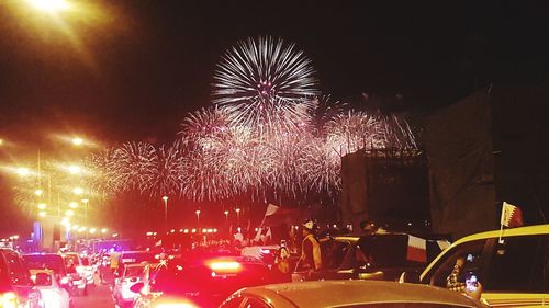 Low angle view of firework display at night