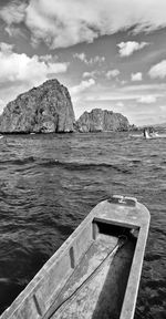 Scenic view of rocks by sea against sky