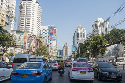 View of city street and buildings against sky