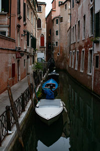 View of canal amidst buildings in city