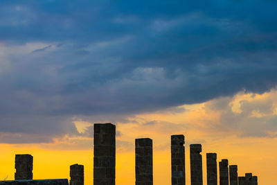 Low angle view of silhouette buildings against sky during sunset