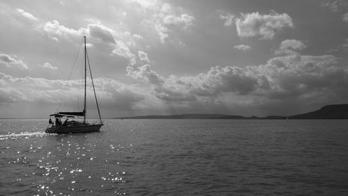 Ship sailing on sea against sky