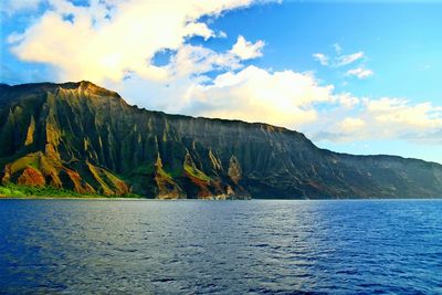 Scenic view of lake by mountains against sky