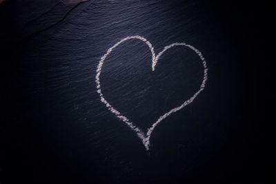 Heart shape with text on black background