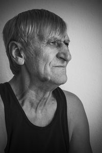 Close-up of man looking away against wall