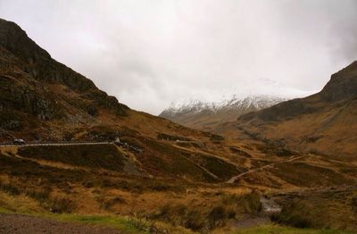 Scenic view of mountains against cloudy sky