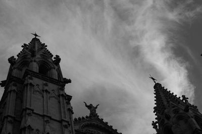 Low angle view of building against cloudy sky