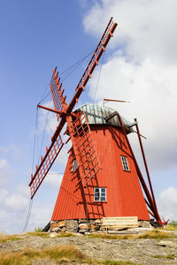 Red windmill on a hill