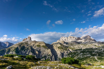 Scenic view of mountains against blue sky