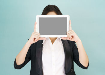 Low angle view of woman standing against white background