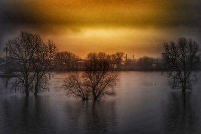 Scenic view of lake against sky at sunset