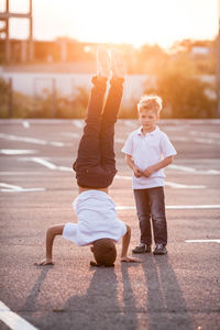Full length of boy doing headstand outdoors