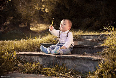 Boy sitting in grass