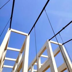 Low angle view of bridge against clear blue sky