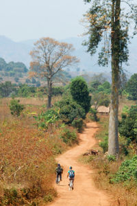 People walking on mountain against sky