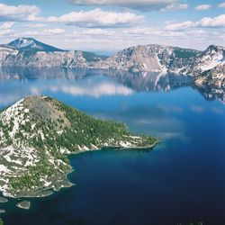 Aerial view of sea and mountains against sky