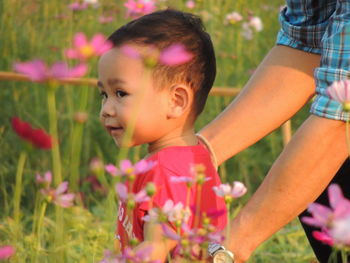 Midsection of mother holding cute daughter while standing on land