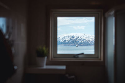 Scenic view of snowcapped mountains seen through window