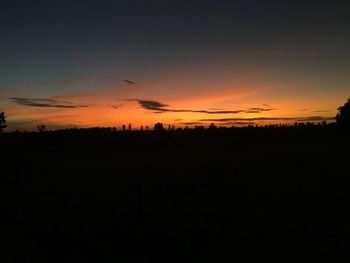 Silhouette landscape against romantic sky at sunset