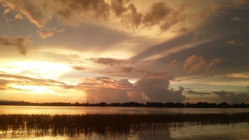 Reflection of clouds in lake at sunset
