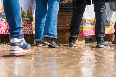 Low section of people walking on floor