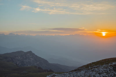 Scenic view of mountains against sky during sunset