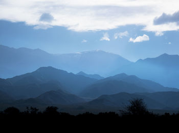 Scenic view of silhouette mountains against sky during sunset