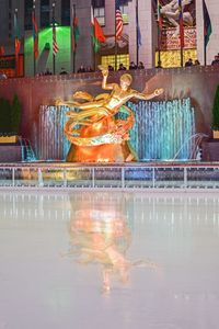 Reflection of illuminated built structure in water