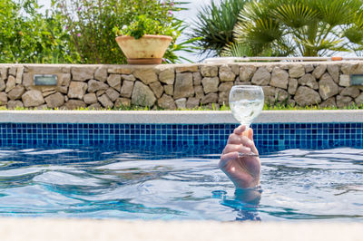 Man drinking water in swimming pool