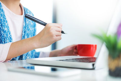 Midsection of businesswoman working in office