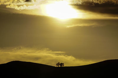 Scenic view of silhouette land against sky during sunset