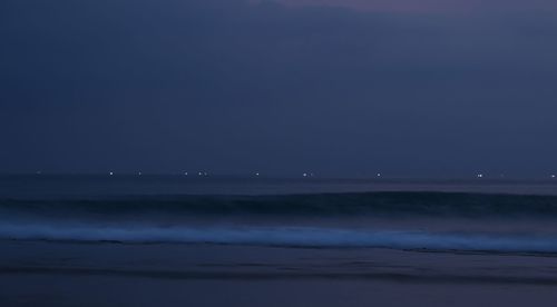 Scenic view of sea against clear sky at night