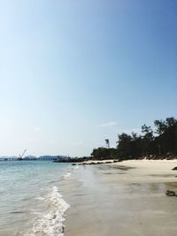 Scenic view of beach against clear blue sky