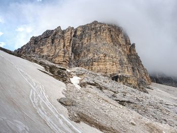 Tre cime di lavaredo rocks hidden in gentle fog. early summer trip in dolomites in italy.