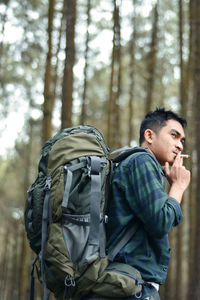 Young man standing in forest