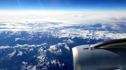 Aerial view of snowcapped mountains against sky