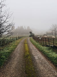 Road passing through landscape against sky