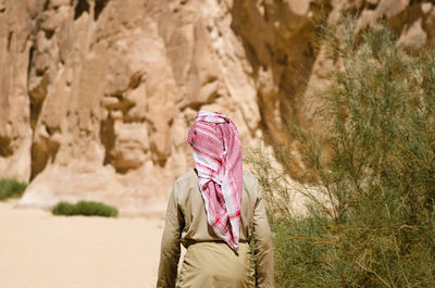 Midsection of woman standing on rock