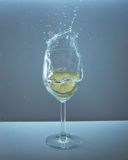 Close-up of glass of water splashing on table