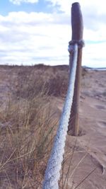 Close-up of sand on beach against sky