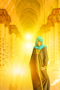 Man standing in illuminated temple