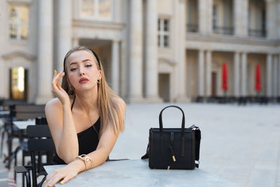 Young woman using mobile phone in city